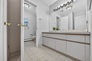 Second floor main bath featuring dual sinks and a separate shower and toilet area. A freshly painted second-floor laundry room keeps daily tasks conveniently close to the bedrooms.