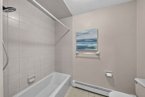 Second floor main bath featuring dual sinks and a separate shower and toilet area. A freshly painted second-floor laundry room keeps daily tasks conveniently close to the bedrooms.