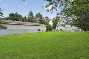 Step outside to an oversized wood deck overlooking the expansive backyard , larger than others, with almost one acre.
