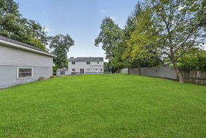 Step outside to an oversized wood deck overlooking the expansive backyard , larger than others, with almost one acre.