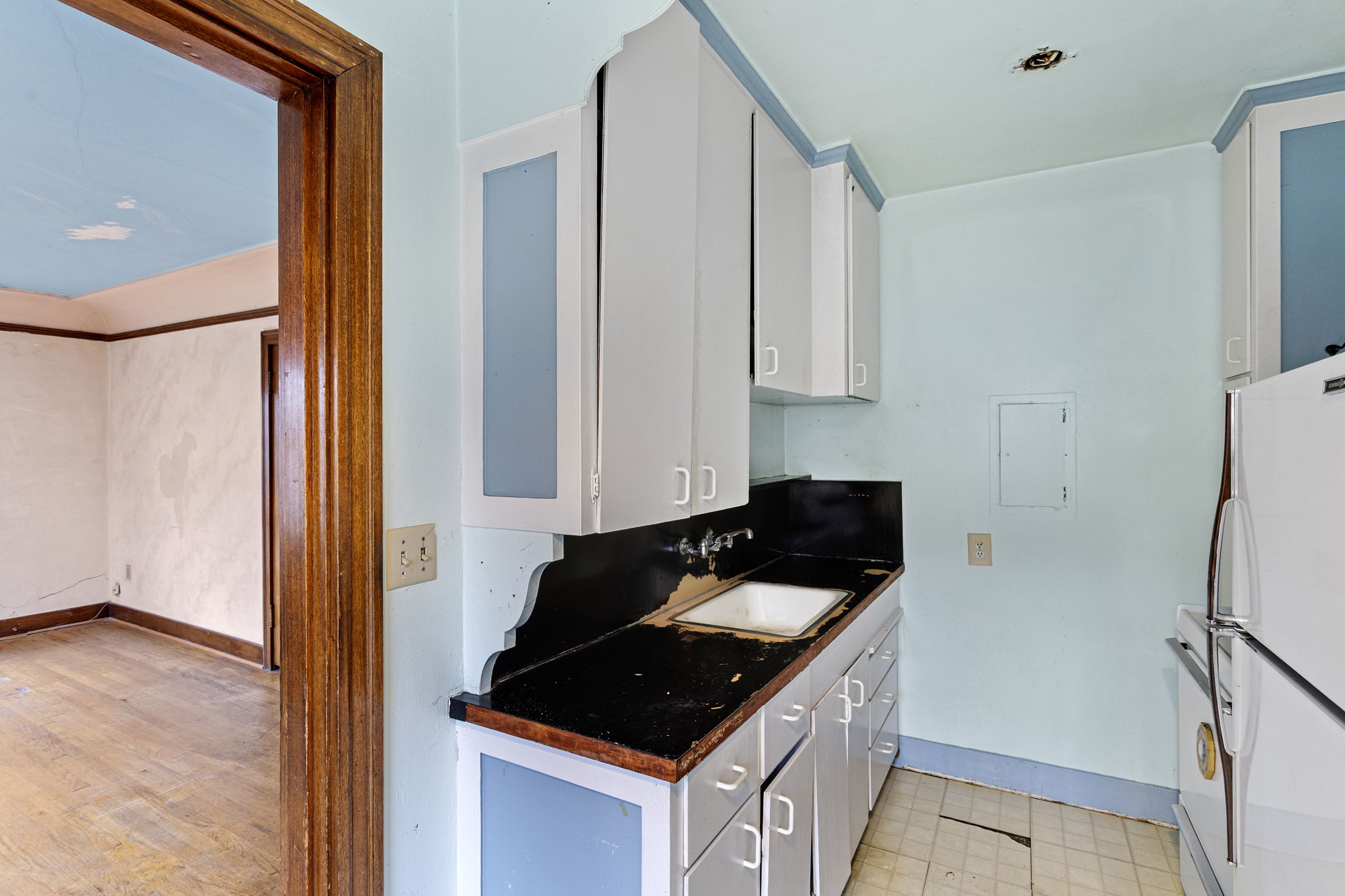 Original kitchen cabinetry and vintage trim offer charm and a blank slate for your dream design.