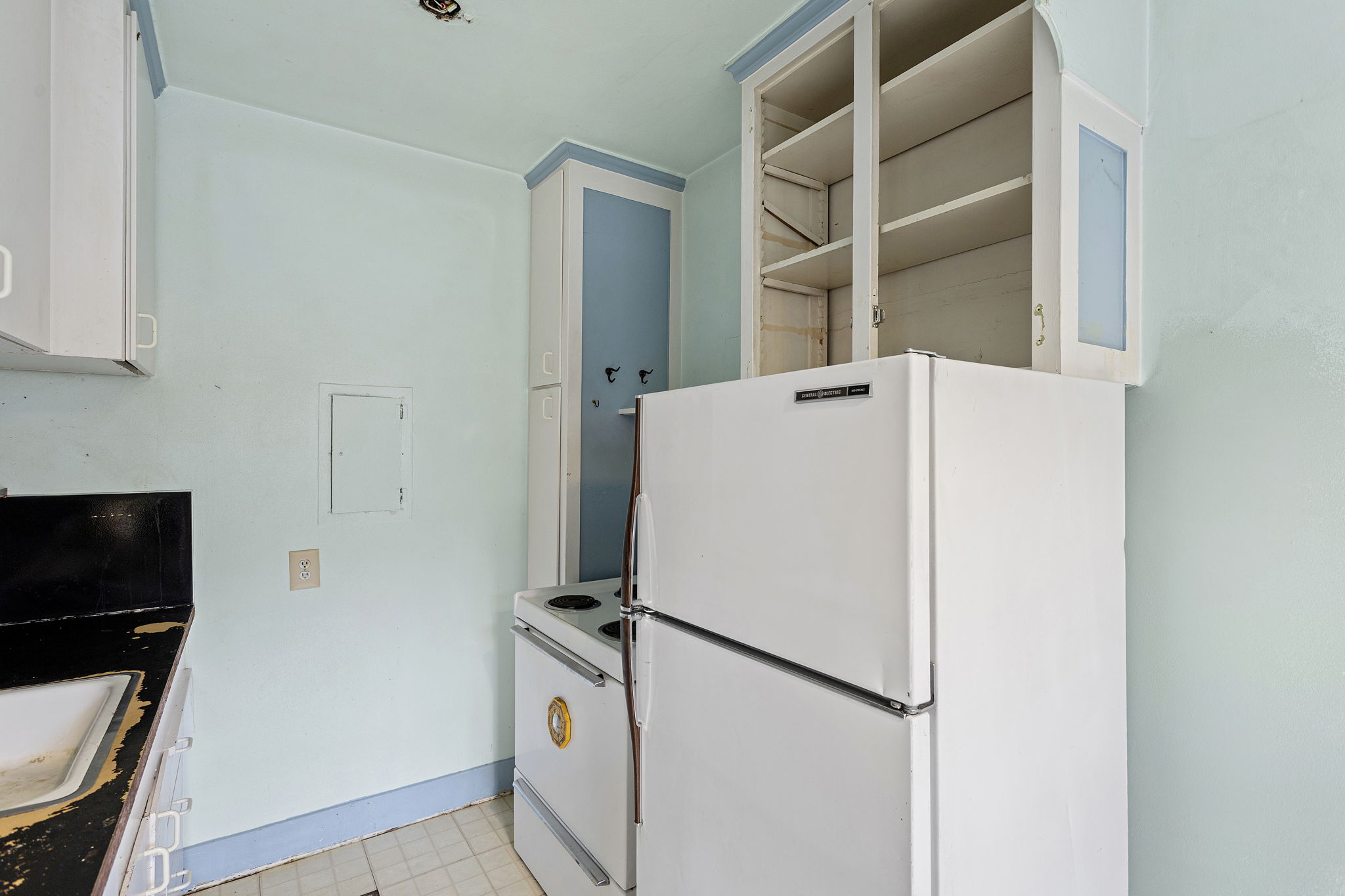 Vintage appliances and built-ins evoke a bygone era—ready for restoration or reinvention.