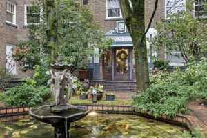 Garden Court’s central fountain and brick-lined courtyard create a serene, storybook welcome—framed by mature trees, lush plantings, and timeless architectural detail.