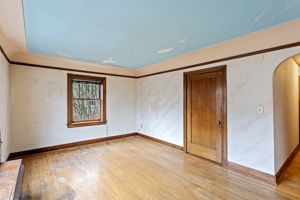 A welcoming space full of vintage charm—original mahogany trim, arched entryways, warm natural light, and a walk-in closet of its own.