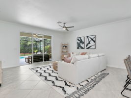 Big Living room opens to Marble-tiled Lanai and Pool area