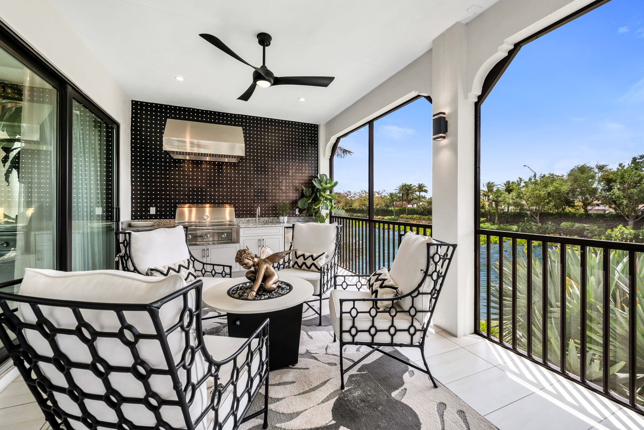 View 1 - An expansive lanai featuring a summer kitchen with serene waterway views.