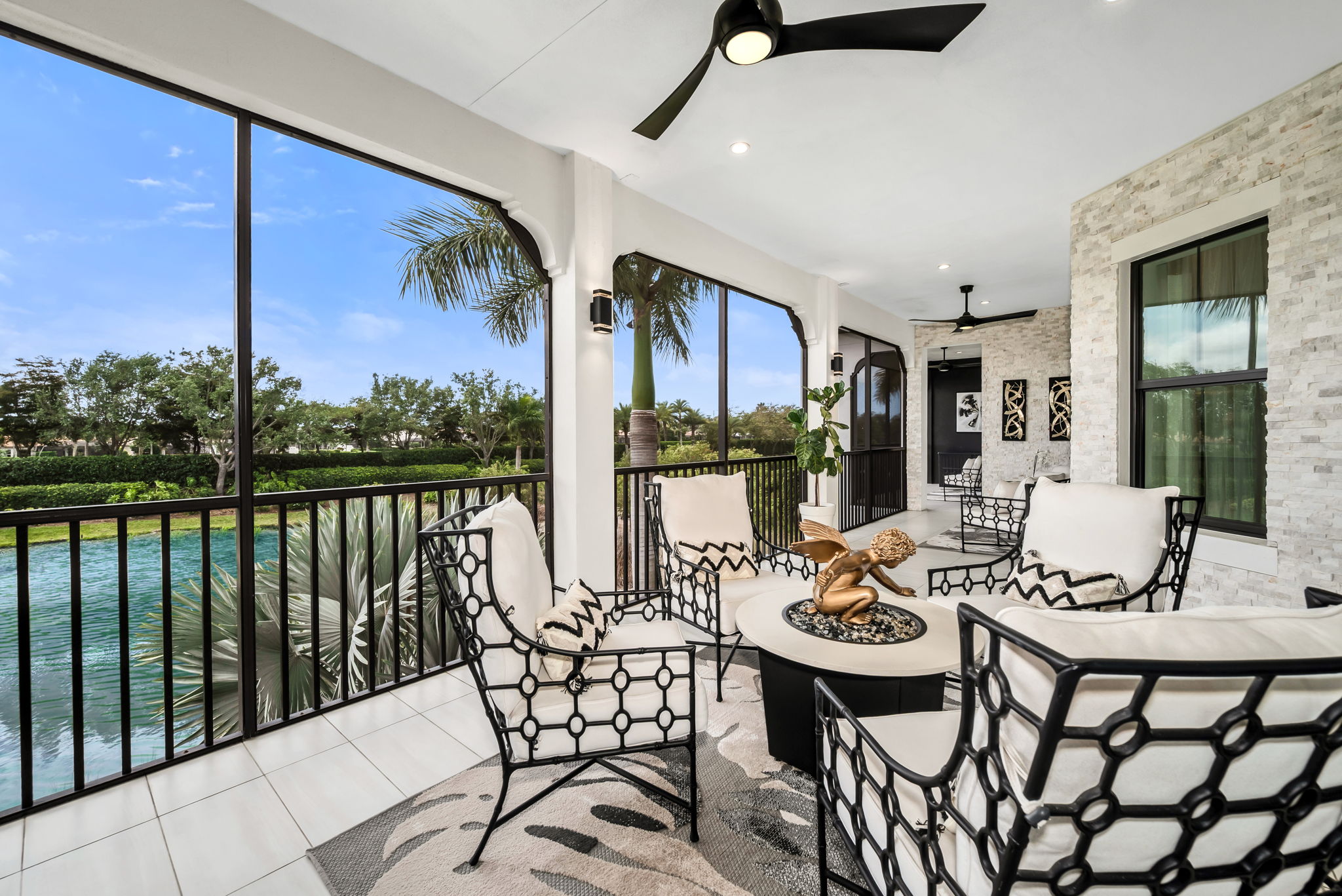 View 2 - An expansive lanai featuring a summer kitchen with serene waterway views.