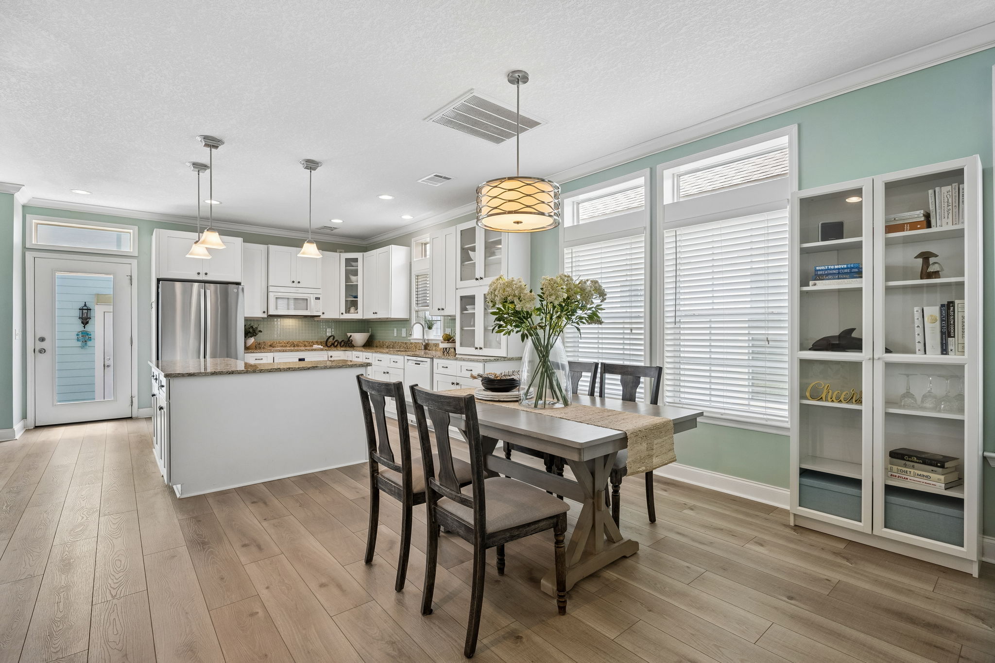 ... anchored by generous cabinetry, granite counters, and a large working island in the kitchen.