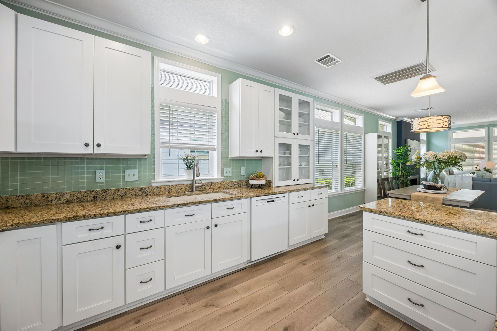 ... while abundant windows and transoms carry light throughout the heart of the home.