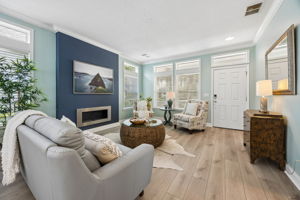 Natural light moves through a long run of windows and transoms ...