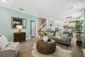 ... while the living room adds warmth and character with its striking accent wall and fireplace.