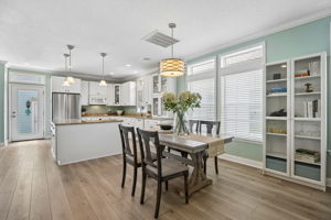 ... anchored by generous cabinetry, granite counters, and a large working island in the kitchen.