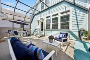 Beyond the main living spaces, the fully screened deck opens as a private outdoor retreat ...