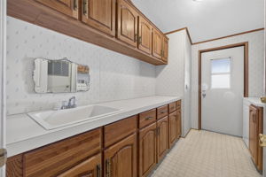 Laundry Room w/ Sink, Washer, Dryer & Carport Entrance