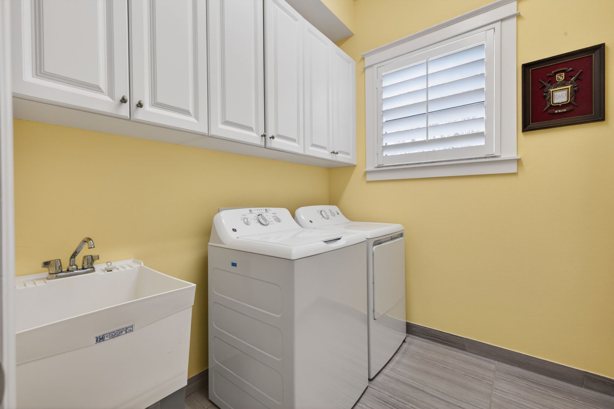 Lots of cabinets for storage and a laundry tub here!