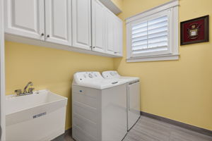 Lots of cabinets for storage and a laundry tub here!