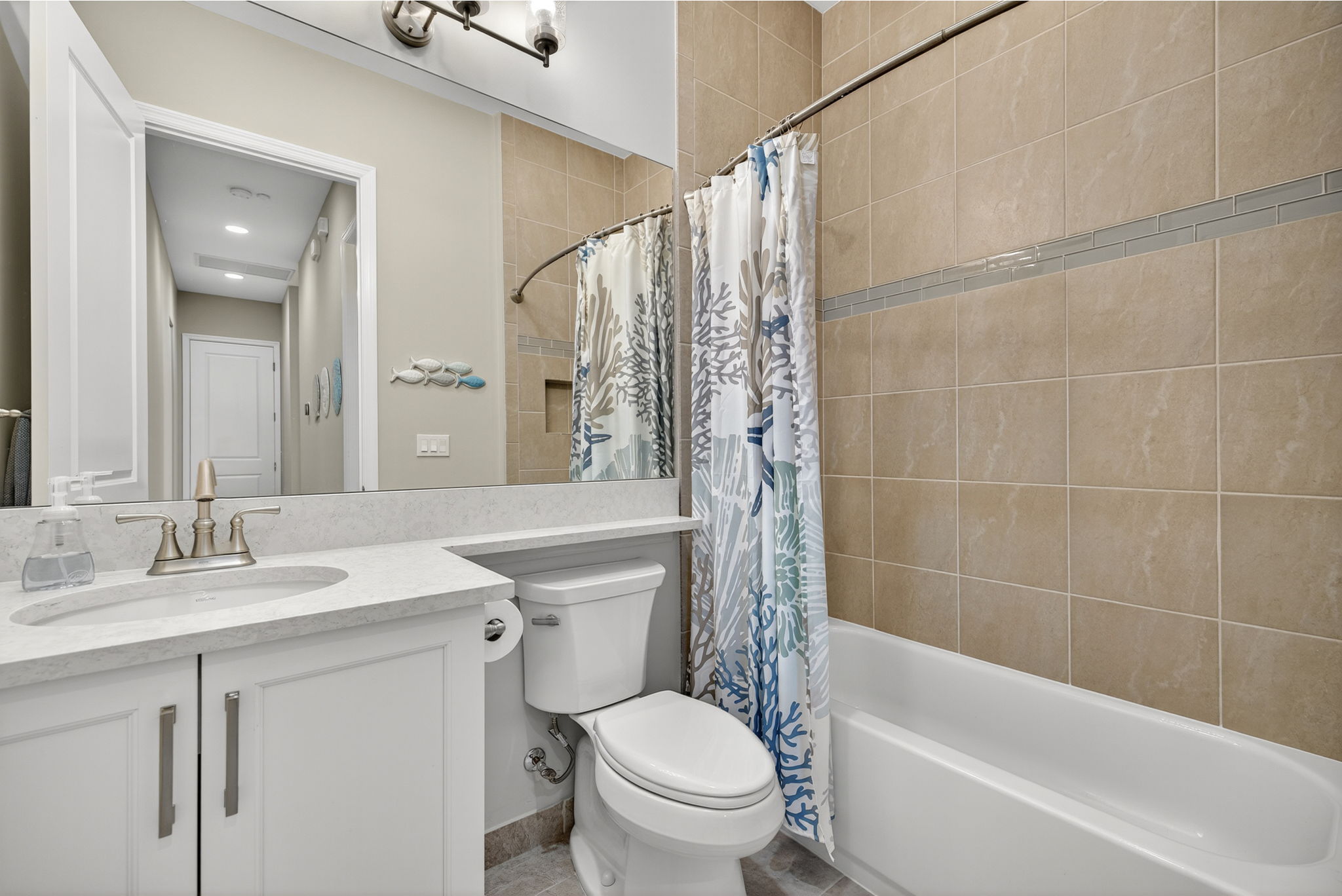 shared bath for guest features upgraded floor to ceiling tiles