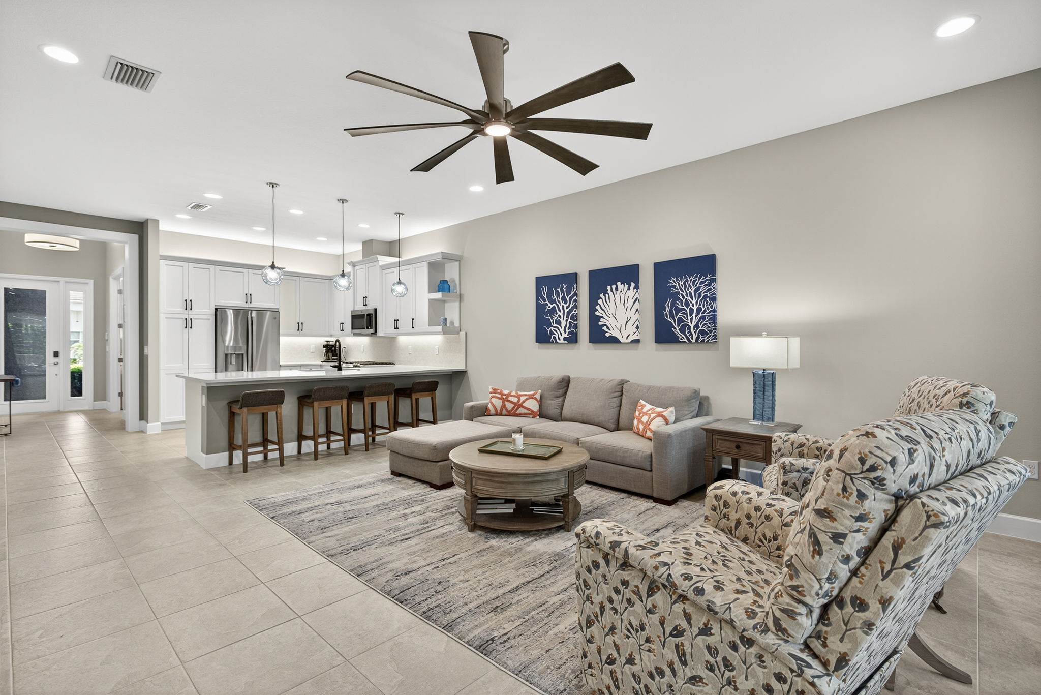 This floor plan is popular because of the openness from foyer to rear of home, w/ separate dining room and wide open living space. Beautiful, glass pendant lighting!