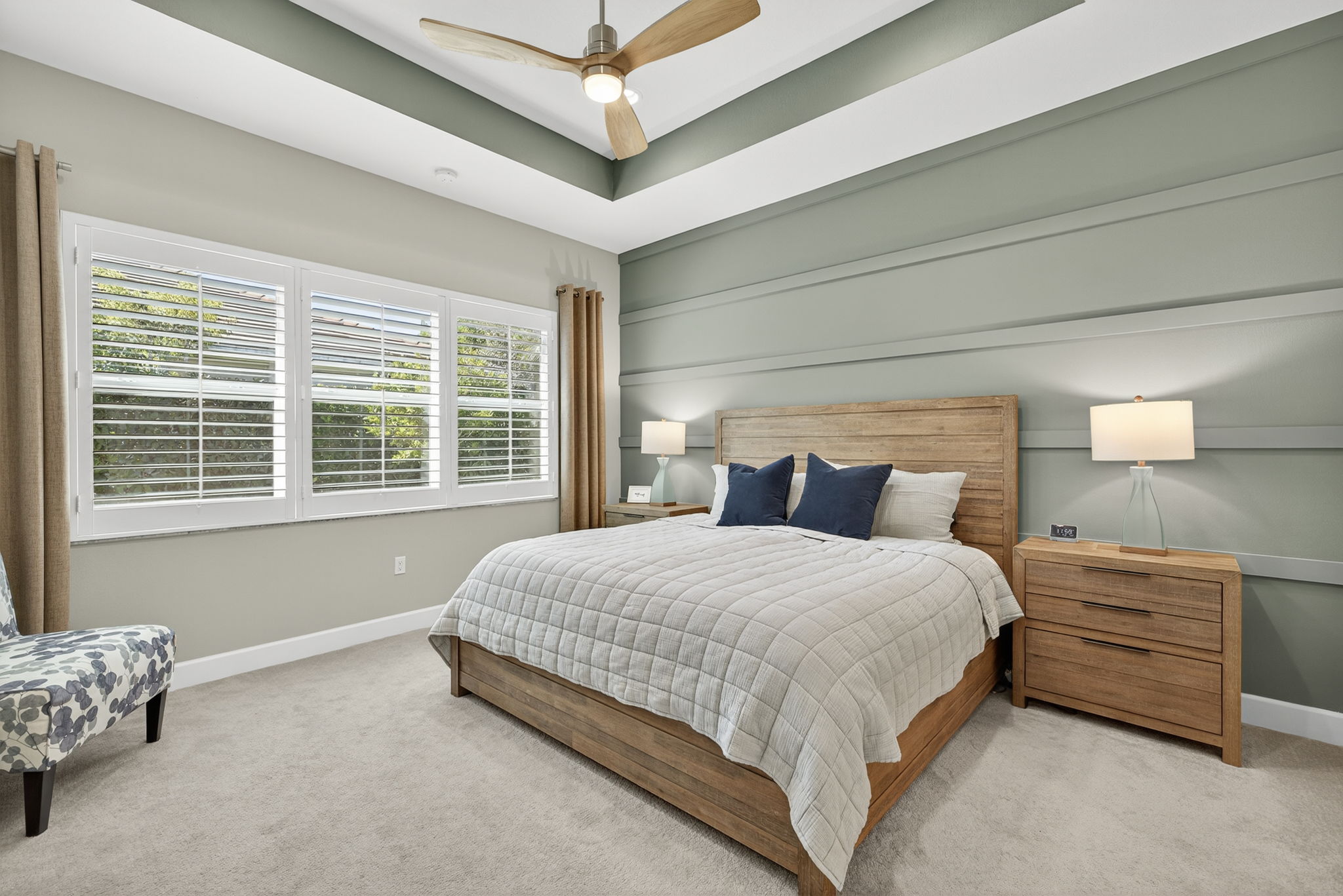 Lovely accent wall and plantation shutters make this primary bedroom special. Large enough to hold a king sized bed, 2 nightstands, a chair and a triple dresser!