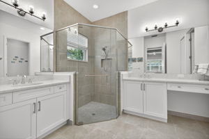 Note the Upgrades of seamless shower door and floor to ceiling tiles in shower are vanity area, ladies!