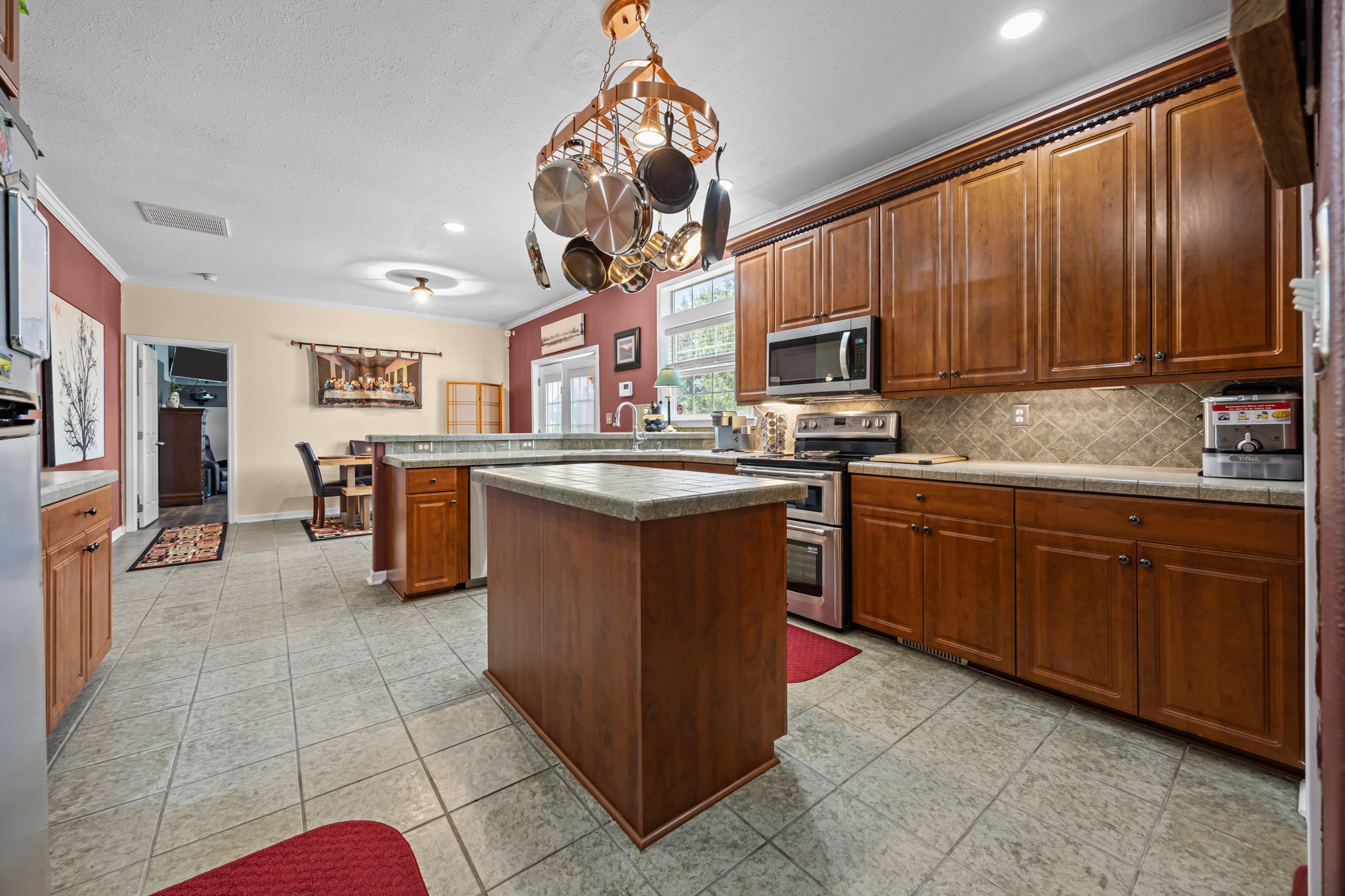 Kitchen with Copper Pot holder over tile topped island