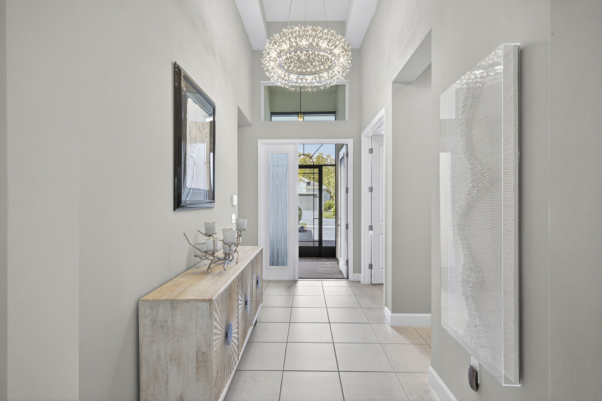 Impressive foyer with tray ceiling and gorgeous chandelier!