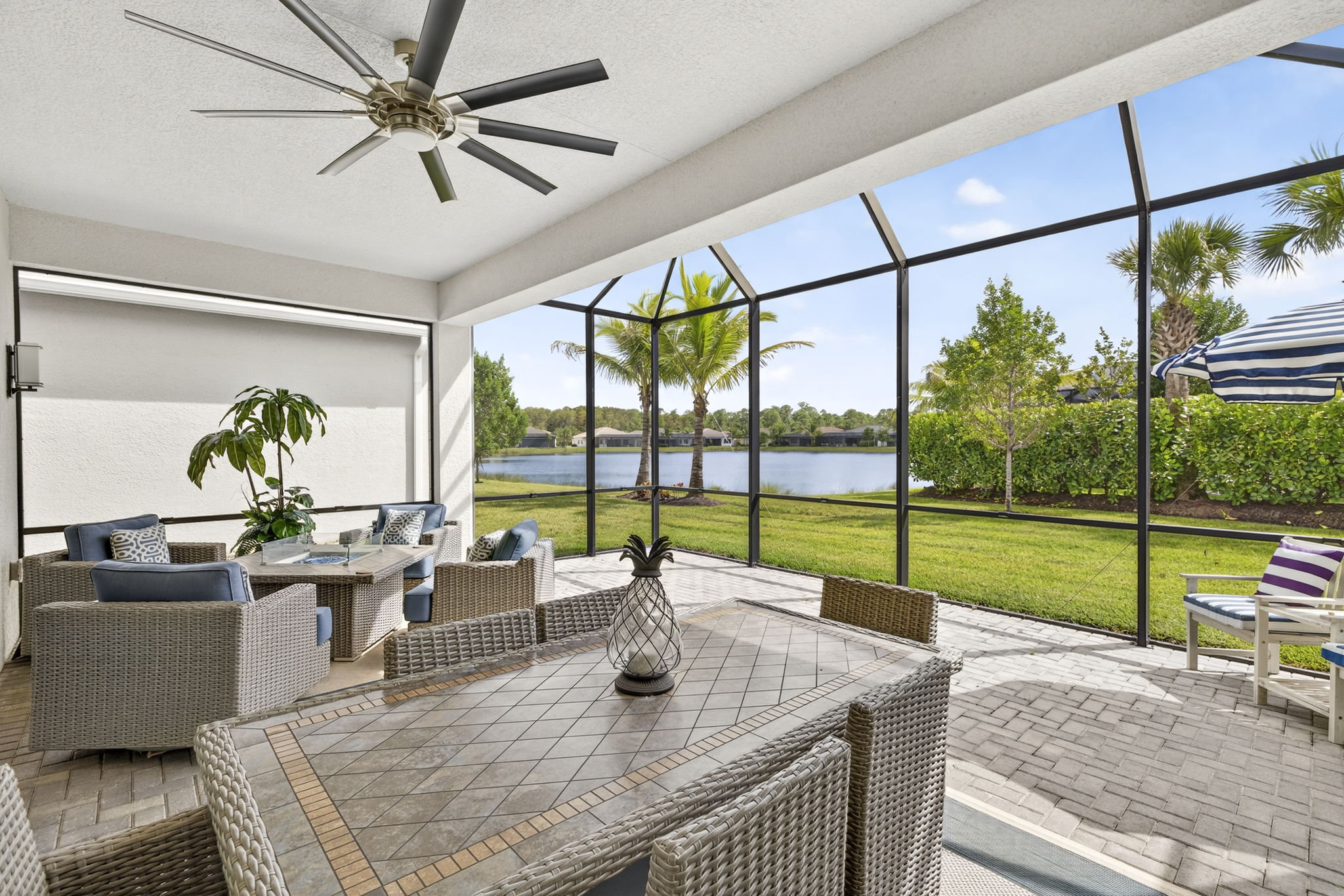 The Storm Smart screen to the left is closed. This extended lanai expands your living space tremendously! TV hook-up present. What a serene view!