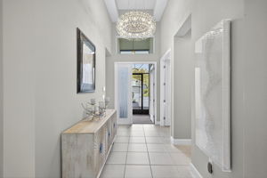 Impressive foyer with tray ceiling and gorgeous chandelier!