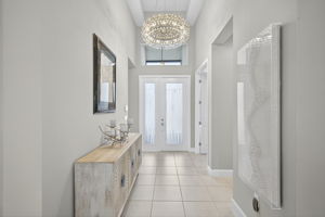 Impressive foyer with tray ceiling and gorgeous chandelier!