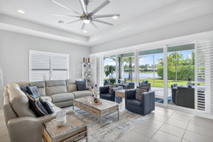 Airy, bright and spacious! This great room comfortably seats 7 plus room to pull up more chairs for book club! Wood plantation shutters across all 4 center opening doors to covered, extended lanai area.