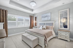 Plenty of room for a king sized bed and large dresser, plus a chair! Lighting above night stands convey.