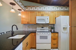 kitchen-granite counters, wood cabinetry