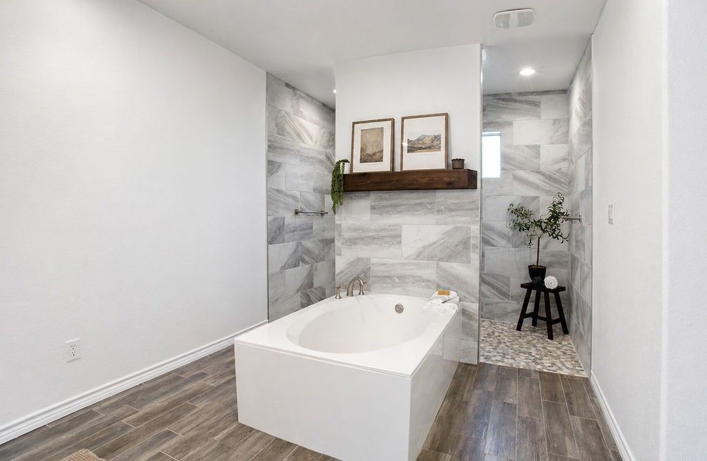 Soaking tub and walk-in shower in the primary bathroom.