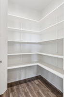 A walk-in pantry with plenty of storage.
