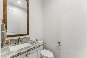 Half bath off the kitchen and living area.