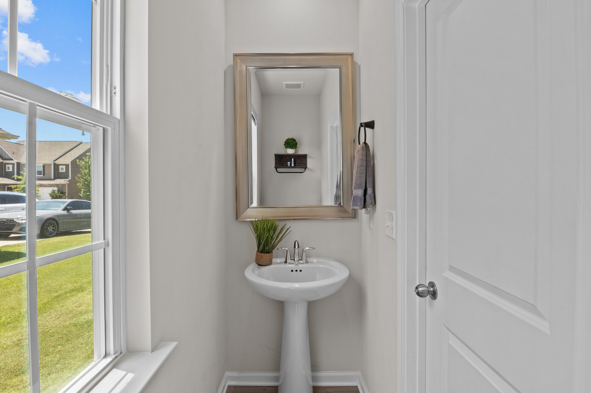 Powder room off to the side of the kitchen as you enter from the garage