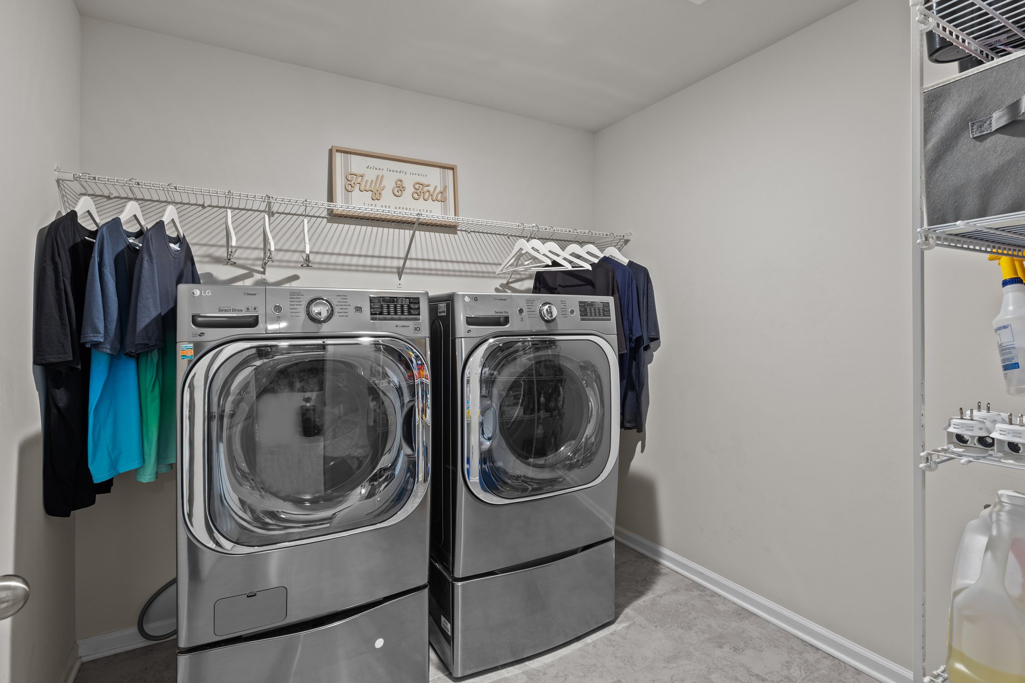 Roomy laundry room with floor to ceiling storage shevling