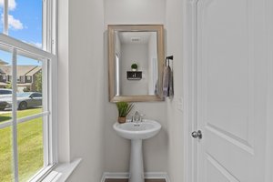Powder room off to the side of the kitchen as you enter from the garage