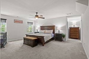 Large primary bedroom that overlooks the treed backyard