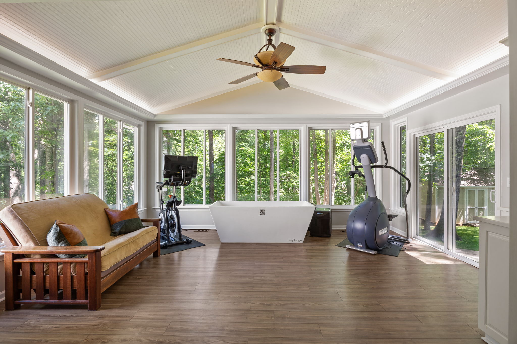 Sunroom addition overlooks wooded greenspace