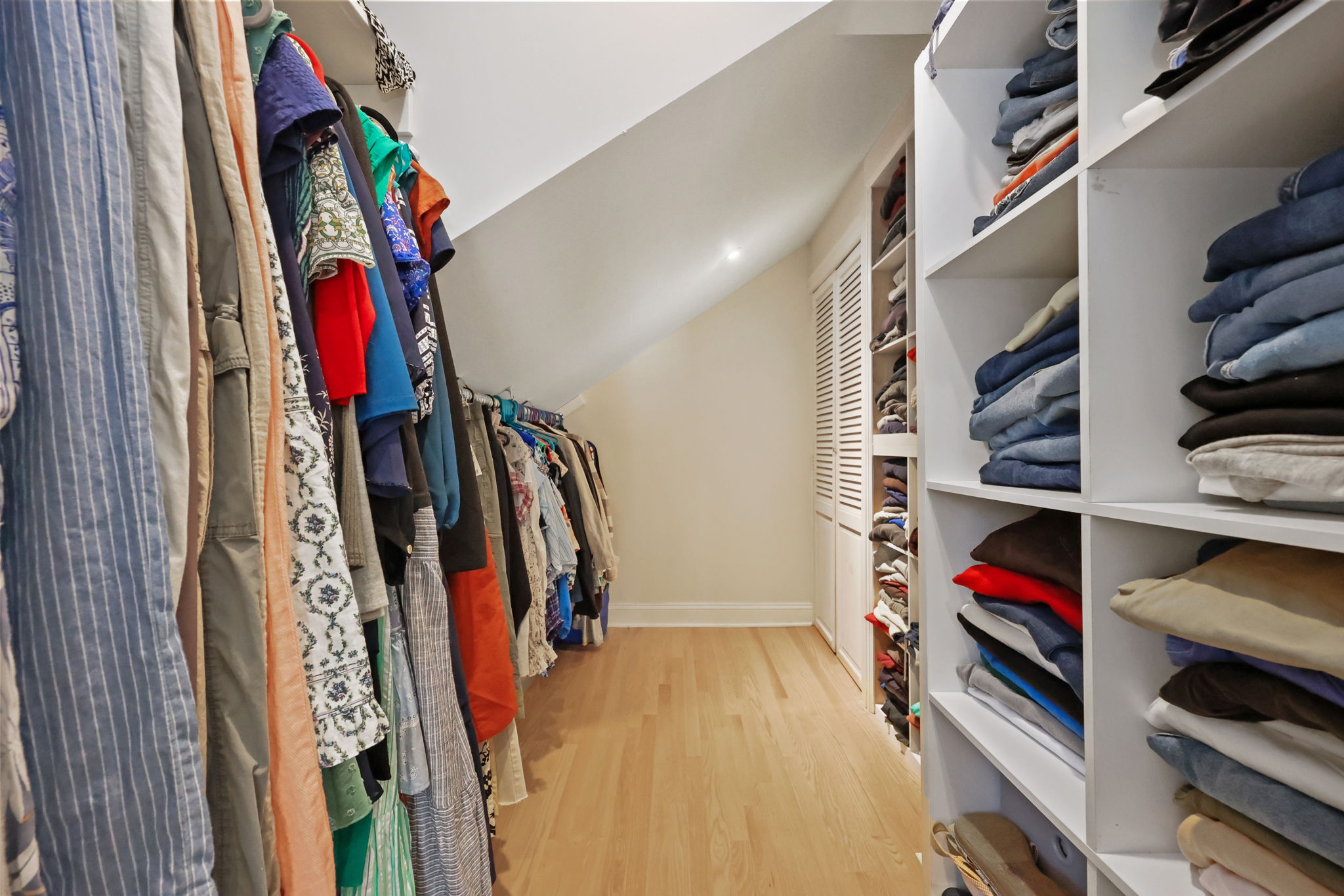 Walk-in closet with access to walk-up attic for additional storage.