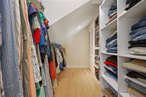 Walk-in closet with access to walk-up attic for additional storage.