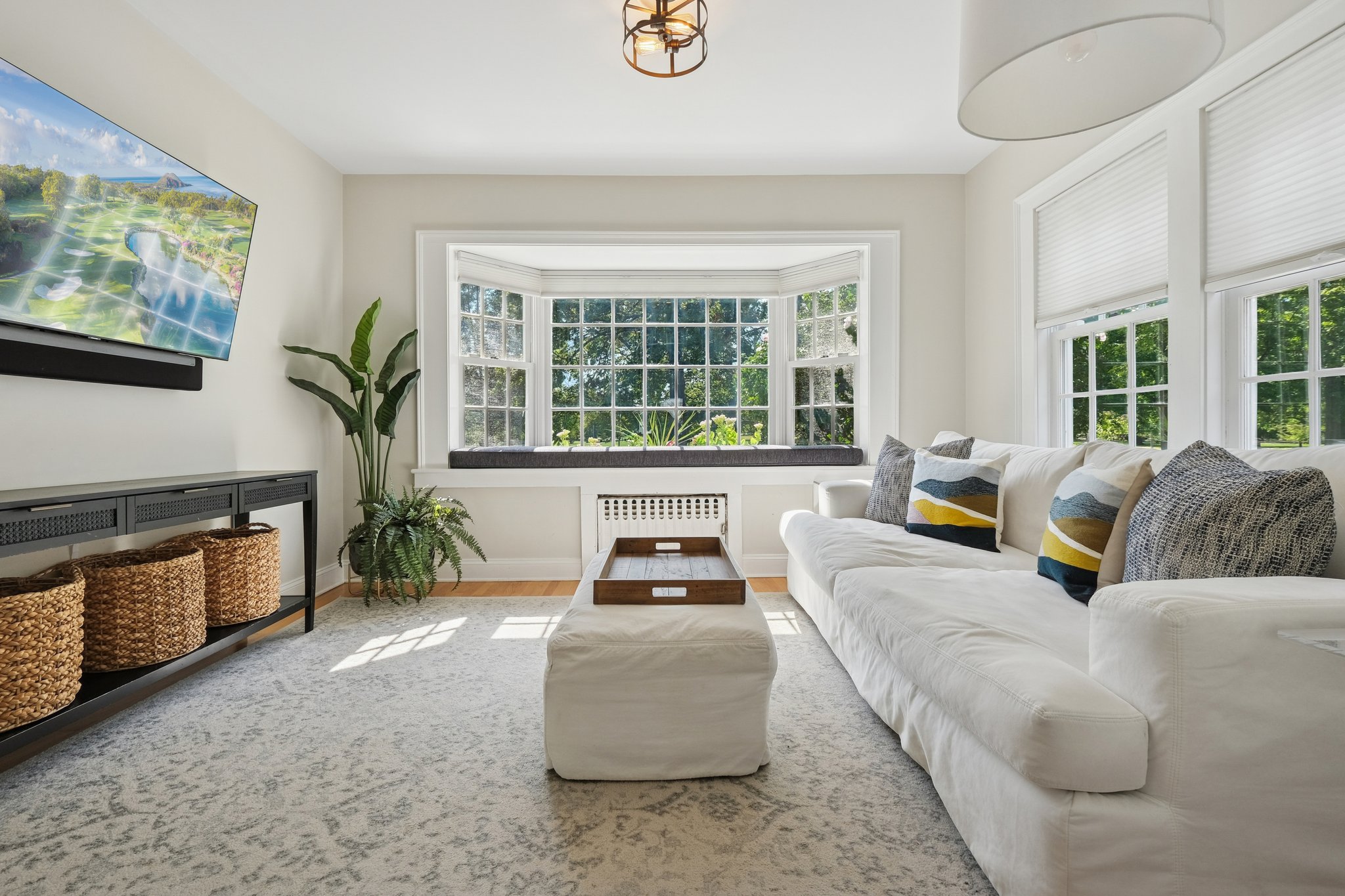 Windows that frame the park like art and invite you to linger - a family room view doesn’t get better than this one.