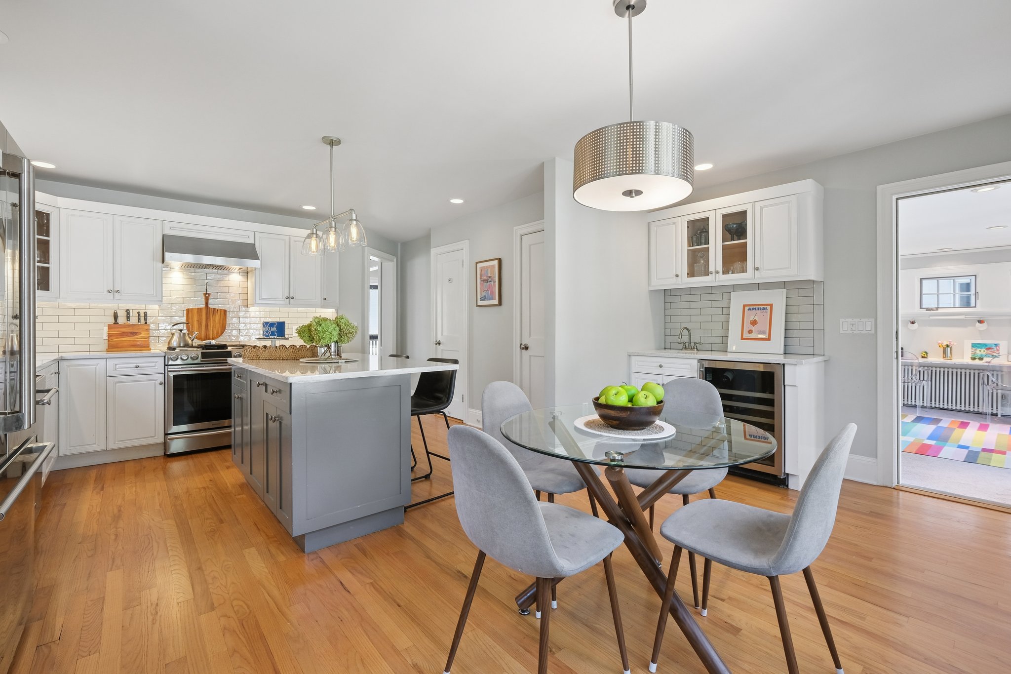 Bright windows to the backyard, a powder room nearby, and a playroom just beyond - this kitchen is where real life works beautifully.