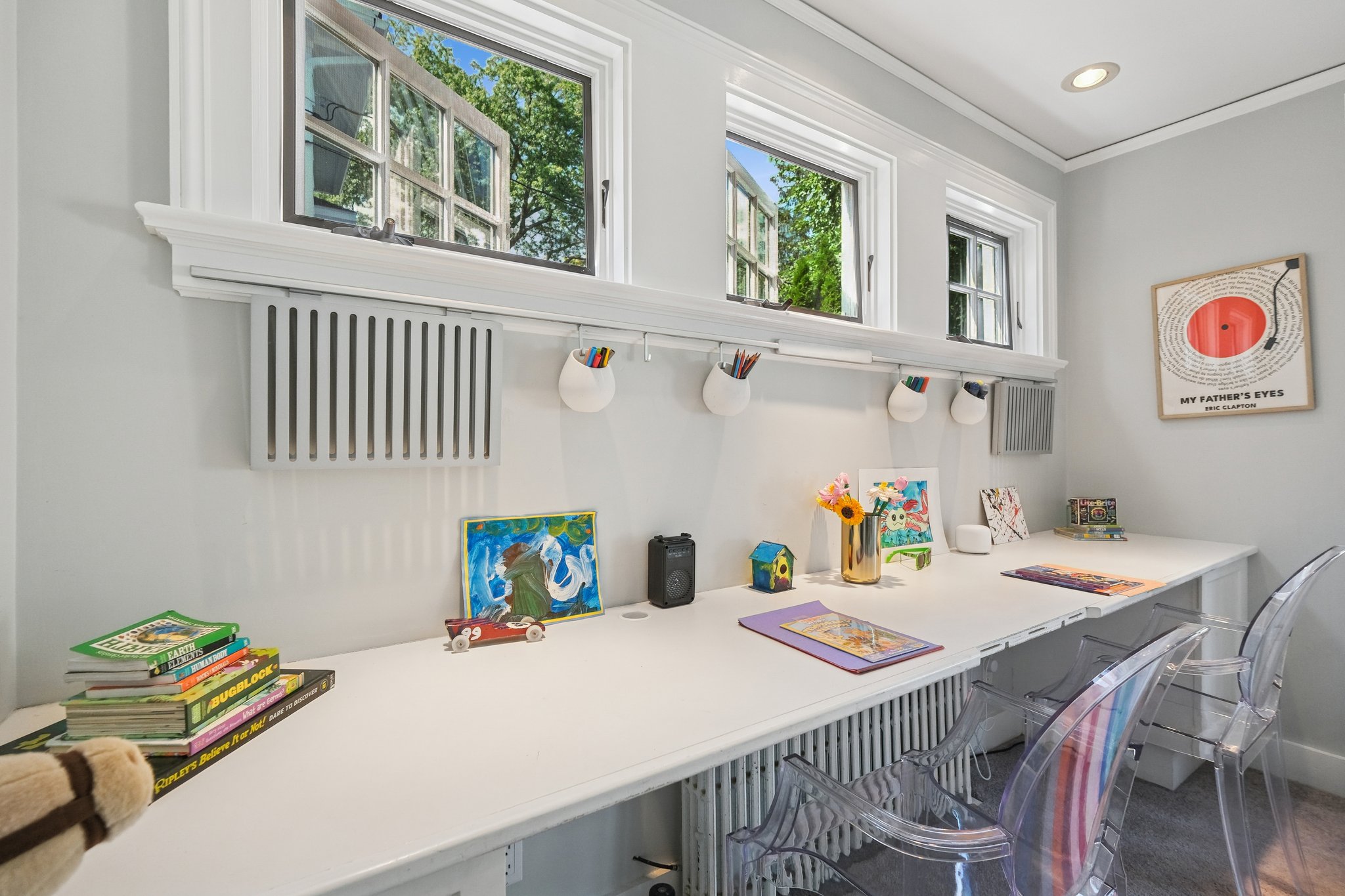 A dedicated work/homework nook with transom windows that flood the desk area with natural light - study time never looked so good.