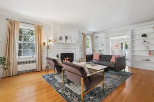 Anchored by a wood-burning fireplace and chic built-ins, this living room is both stylish and practical - a beautiful space that connects seamlessly to the play room (and then kitchen) on one end and family room on the other. See floorplan for more details.
