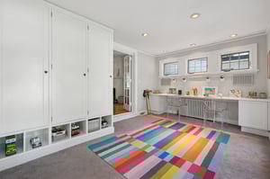 A smart, versatile space with built-in lockers that keep everything from backpacks to board games neatly tucked away.
