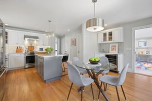 Bright windows to the backyard, a powder room nearby, and a playroom just beyond - this kitchen is where real life works beautifully.
