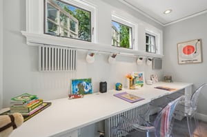 A dedicated work/homework nook with transom windows that flood the desk area with natural light - study time never looked so good.