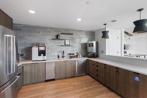 Full size kitchen and coffee bar in owners lounge